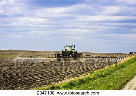 Agriculture - Applying pre-emergent herbicide with a John Deere 4720 sprayer to a newly planted soybean field with the purpose of decreasing weed pressure while optimizing yield potential / Central Iowa, USA. View Large Photo Image Stock Photo - Agriculture - Applying pre-emergent herbicide with a John Deere 4720 sprayer to a newly planted soybean field with the purpose of decreasing weed pressure while optimizing yield potential / Central Iowa, USA.. Fotosearch