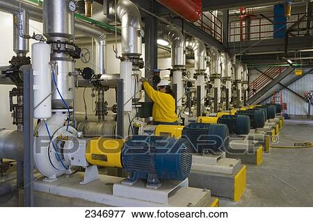 Stock Photo - Agriculture - Ethanol production plant. A technician prepares to take an ethanol sample at the cooking units / Iowa, USA.. Fotosearch