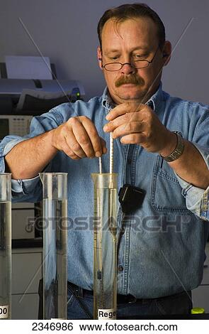 Agriculture - Ethanol production plant. A technician tests the quality of ethanol samples in the quality control laboratory / Iowa, USA. View Large Photo Image Stock Photograph - Agriculture - Ethanol production plant. A technician tests the quality of ethanol samples in the quality control laboratory / Iowa, USA.. Fotosearch