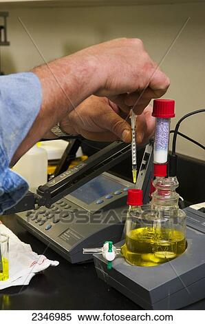 Agriculture - Ethanol production plant. A technician tests a sample of ethanol in the quality control laboratory / Iowa, USA. View Large Photo Image Stock Photography - Agriculture - Ethanol production plant. A technician tests a sample of ethanol in the quality control laboratory / Iowa, USA.. Fotosearch