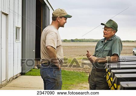 Agriculture - Father and son farmers discuss Spring planting operations on their farm / Central Iowa, USA. View Large Photo Image Stock Image - Agriculture - Father and son farmers discuss Spring planting operations on their farm / Central Iowa, USA.. Fotosearch