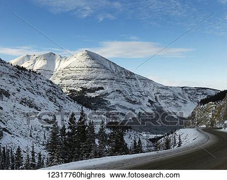 Stock Photograph - Alaska highway through the Rocky Mountains; British Columbia, Canada. Fotosearch