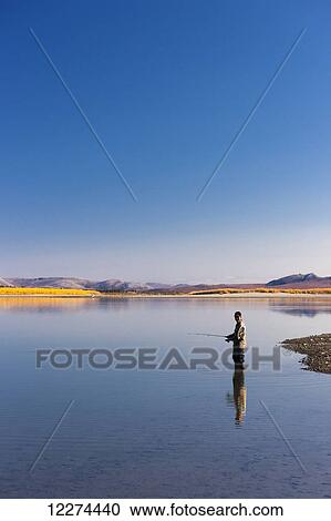 Stock Image - Alaska Native elder fishing in the Noatak River, Noatak, Arctic Alaska, USA, Autumn. Fotosearch
