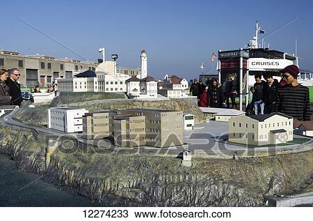 Stock Image - Alcatraz plaza, visitors look at model of the island prison while waiting for the boat; San Francisco, California, United States of America. Fotosearch