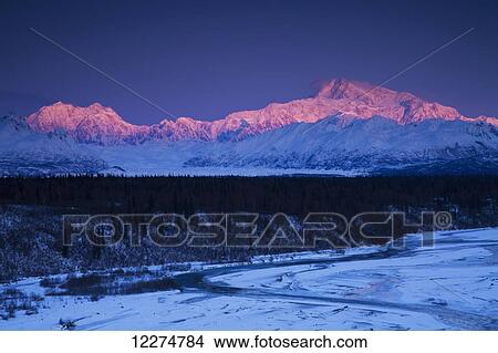 Picture - Alpenglow on Mt. McKinley and Mt. Hunter as seen from the Denali South Overlook along the Parks Highway, Denali State Park, Alaska, Winter. Fotosearch