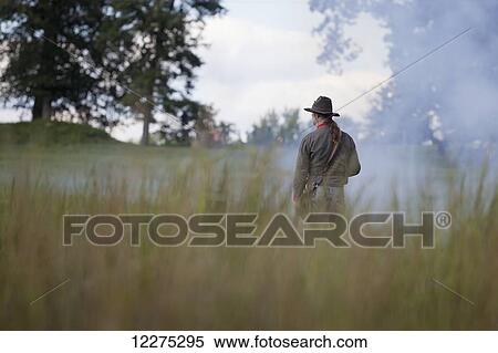American Civil War confederate re-enactor with his back to the camera, surveying the smoke-filled battlefield; United States of America View Large Photo Image Stock Photography - American Civil War confederate re-enactor with his back to the camera, surveying the smoke-filled battlefield; United States of America. Fotosearch