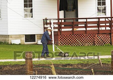 Amish man mowing lawn, near Hazelton; Iowa, United States of America View Large Photo Image Stock Photograph - Amish man mowing lawn, near Hazelton; Iowa, United States of America. Fotosearch