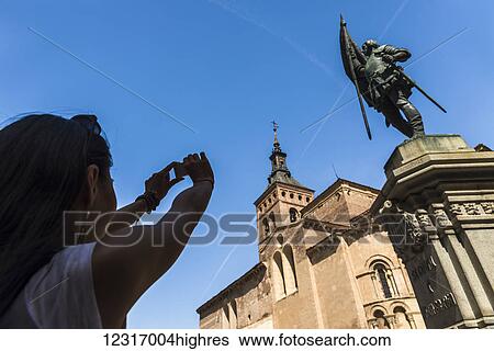 An asian young woman taking a picture of San Martin Church and Juan Bravo statue, Romanic style construction; Segovia, Castilla Leon, Spain View Large Photo Image Stock Photograph - An asian young woman taking a picture of San Martin Church and Juan Bravo statue, Romanic style construction; Segovia, Castilla Leon, Spain. Fotosearch