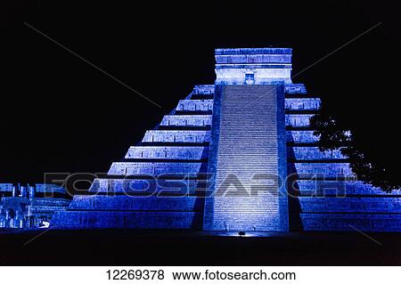 Stock Photo - Ancient Mayan Pyramid at night illuminated with blue light; Chichen Itza, Yucatan, Mexico. Fotosearch