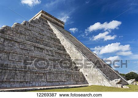 Ancient Mayan Pyramid with two large serpent heads with their mouths open and white clouds and blue sky; Chichen Itza, Yucatan, Mexico View Large Photo Image Stock Photo - Ancient Mayan Pyramid with two large serpent heads with their mouths open and white clouds and blue sky; Chichen Itza, Yucatan, Mexico. Fotosearch