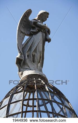 Stock Photograph - Angel Statue Atop A Mausoleum At The Cementerio De La Recoleta, Buenos Aires, Capital Federal, Argentina. Fotosearch