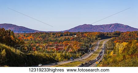 Stock Photograph - Autumn coloured forest along Autoroute 10, Eastern townships; South Stukely, Quebec, Canada. Fotosearch