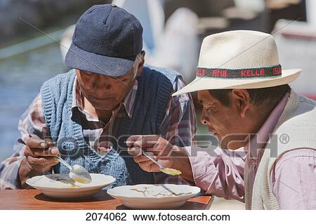 Aymara Men Having Lunch On The Isla Del Sol In Titicaca Lake, La Paz Department, Bolivia View Large Photo Image Stock Image - Aymara Men Having Lunch On The Isla Del Sol In Titicaca Lake, La Paz Department, Bolivia. Fotosearch