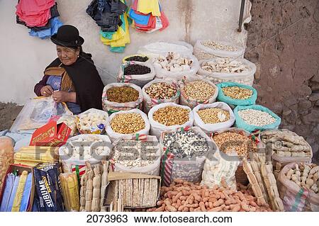 Stock Image - Aymara Woman Selling Pasankalla (Puffed Corn) And Dried Fruits And Nuts, Copacabana, La Paz Department, Bolivia. Fotosearch