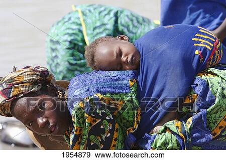 Stock Photo - Baby on woman's back in Sebi, Mali. Fotosearch