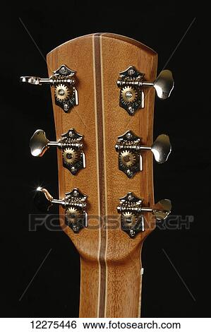 Stock Photograph - Back of the head stock of an acoustic guitar, showing the tuning pegs and wood detail; United States of America. Fotosearch