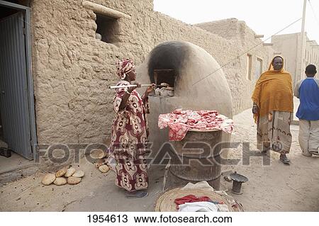 Baking bread in mud oven in Timbuktu, Mali View Large Photo Image Stock Image - Baking bread in mud oven in Timbuktu, Mali. Fotosearch