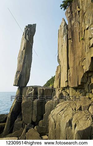 Stock Photograph - Balancing rock, basalt rock cliffs, Bay of Fundy; Long Island, Nova Scotia, Canada. Fotosearch