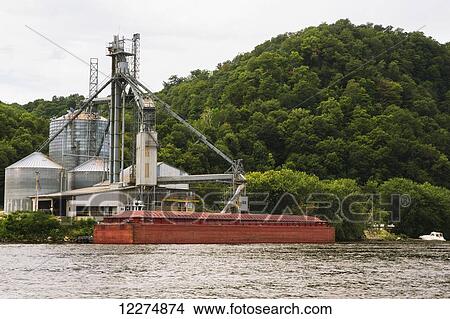 Picture - Barge docked at a grain terminal along the Mississippi River; McGregor, Iowa, United States of America. Fotosearch