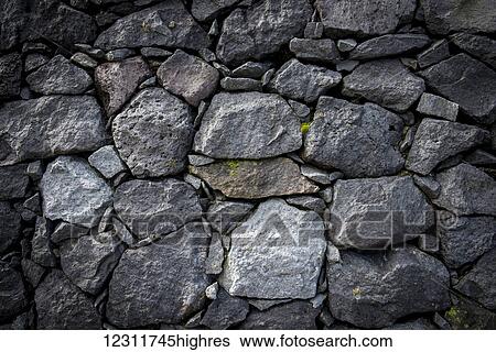 Stock Photograph - Basalt rocks wall in Lagoa das Furnas park; Furnas, Sao Miguel, Azores, Portugal. Fotosearch