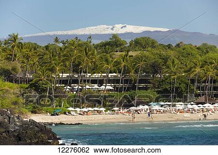 Stock Image - Beach in front of Mauna Kea Beach Hotel, snowcapped Mauna Kea; Island of Hawaii, Hawaii, United States of America. Fotosearch