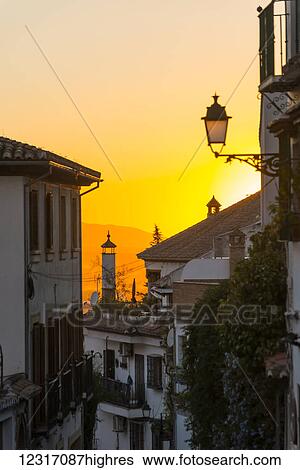 Stock Photograph - Beautiful sunset on the streets of Albaicin neighborhood; Granada, Andalucia, Spain. Fotosearch