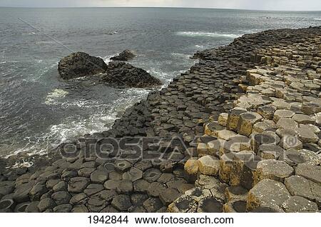 Black Basalt Columns Sticking Out Of The Sea, Giant's Causeway, Northern Ireland, United Kingdom View Large Photo Image Picture - Black Basalt Columns Sticking Out Of The Sea, Giant's Causeway, Northern Ireland, United Kingdom. Fotosearch