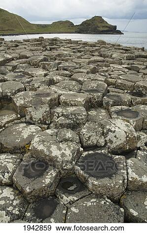 Stock Photo - Black Basalt Columns Sticking Out Of The Sea, Giant's Causeway, Northern Ireland, United Kingdom. Fotosearch