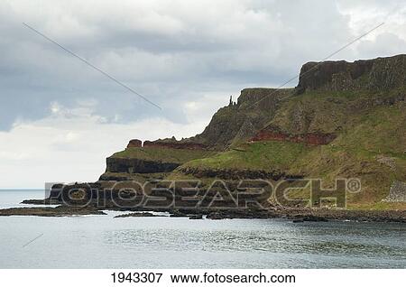 Stock Photo - Black Basalt Columns Sticking Out Of The Sea, Giant's Causeway, Northern Ireland, United Kingdom. Fotosearch