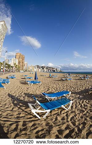 Blue lounge chairs on the beach along the mediterranean; Benidorm, Spain View Large Photo Image Stock Image - Blue lounge chairs on the beach along the mediterranean; Benidorm, Spain. Fotosearch