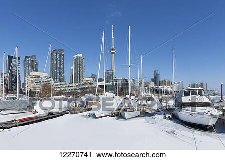 Stock Image - Boats in marina at Harbourfront in winter; Toronto, Ontario, Canada. Fotosearch