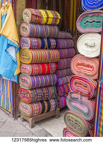 Stock Photograph - Bolts of colourful Peruvian designs in a street market, these patterns are part of the indigenous Quechua culture; Cusco, Peru. Fotosearch