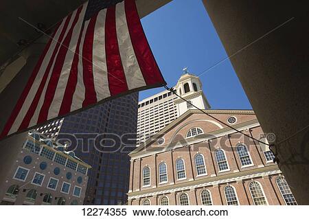 Stock Photography - Boston skyline and an American flag framing the blue sky; Boston, Massachusetts, United States of America. Fotosearch
