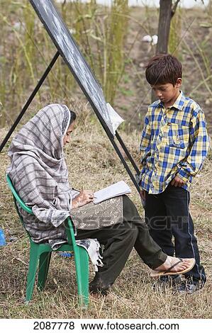 Boy Attending An English Class In An Open Air School Set Up After The 8 October 2005 Earthquake, Subri, Azad Kashmir, Pakistan View Large Photo Image Stock Photo - Boy Attending An English Class In An Open Air School Set Up After The 8 October 2005 Earthquake, Subri, Azad Kashmir, Pakistan. Fotosearch