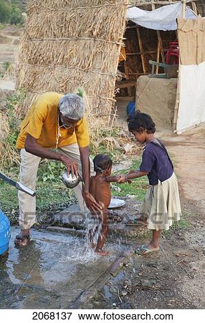 Stock Photo - Boy Getting A Bath At The Well, Rajgir, Bihar, India. Fotosearch