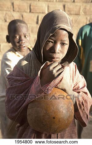 Boy holding pumpkin in Djenne, Mali View Large Photo Image Stock Image - Boy holding pumpkin in Djenne, Mali. Fotosearch