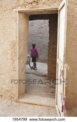 Boy standing in Courtyard at Djenne, Mali View Large Photo Image Stock Photo - Boy standing in Courtyard at Djenne, Mali. Fotosearch