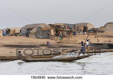 Boys on a boat near a village on the Niger River between Lake Debo and Sebi, Mali View Large Photo Image Stock Image - Boys on a boat near a village on the Niger River between Lake Debo and Sebi, Mali. Fotosearch