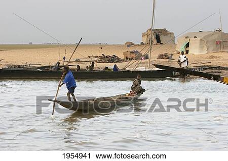 Boys on a boat near a village on the Niger River between Lake Debo and Sebi, Mali View Large Photo Image Stock Image - Boys on a boat near a village on the Niger River between Lake Debo and Sebi, Mali. Fotosearch