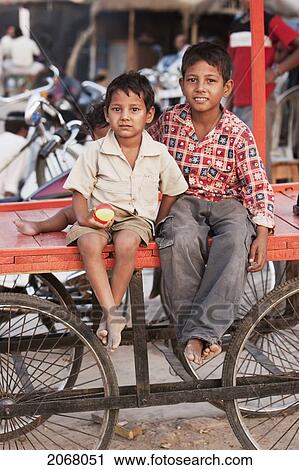 Boys Sitting On A Cart, Bodhgaya, Bihar, India View Large Photo Image Stock Image - Boys Sitting On A Cart, Bodhgaya, Bihar, India. Fotosearch