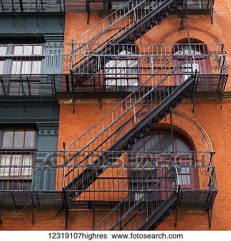 Brick residential building with black metal fire escapes, Soho, Lower Manhattan; New York City, New York, United States of America View Large Photo Image Stock Photograph - Brick residential building with black metal fire escapes, Soho, Lower Manhattan; New York City, New York, United States of America. Fotosearch