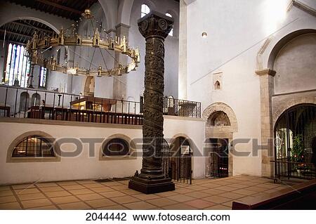 Stock Image - Bronze Column And Chandelier In The Form Of A Wheel Inside St. Mary's Cathedral, Hildesheim, Lower Saxony, Germany. Fotosearch