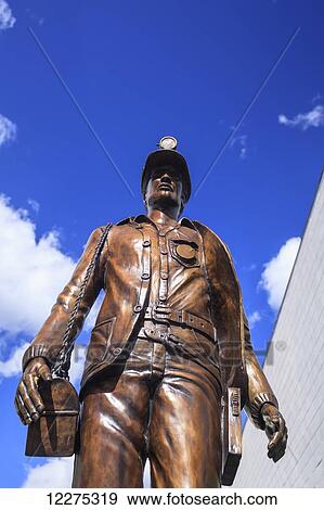 Stock Photo - Bronze miner statue; Canmore, Alberta, Canada. Fotosearch