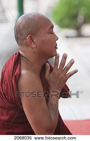 Stock Photography - Buddhist Monk Praying By The Bodhi Tree, Mahabodi Temple, Bodhgaya, Bihar, India. Fotosearch