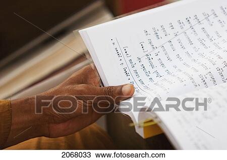 Stock Image - Buddhist Monk Reciting By The Bodhi Tree, Mahabodi Temple, Bodhgaya, Bihar, India. Fotosearch