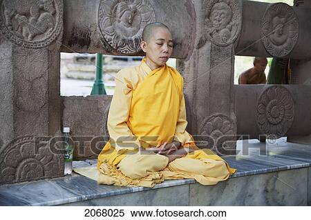 Stock Photography - Buddhist Nun Meditating, Mahabodi Temple, Bodhgaya, Bihar, India. Fotosearch