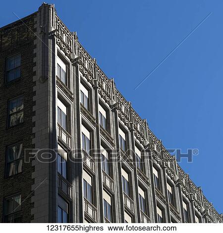 Building with decorative facade along the roofline against a blue sky; Minneapolis, Minnesota, United States of America View Large Photo Image Stock Photograph - Building with decorative facade along the roofline against a blue sky; Minneapolis, Minnesota, United States of America. Fotosearch