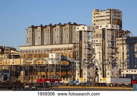 Stock Photograph - Buildings And Trucks At The Port; Montreal, Quebec, Canada. Fotosearch