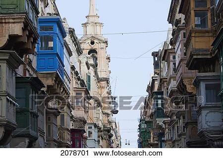 Stock Image - Buildings With Enclosed Balconies And Church, Valletta, Malta. Fotosearch