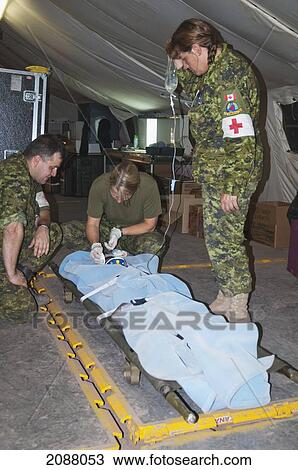 Stock Image - Canada's Dart (Disaster Assistance Response Team) Medical Team Preparing A Patient For Transport At The Field Hospital After The 8 October 2005 Earthquake, Garhi Dopatta, Azad Jammu & Kashmir, Pakistan. Fotosearch